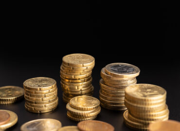 Background of Euro coins on black background. Currency Money. Copy space