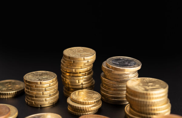 Background of Euro coins on black background. Currency Money. Copy space
